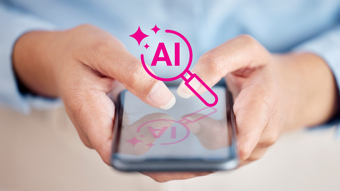 Woman holding a phone with an AI magnifying glass icon over it.