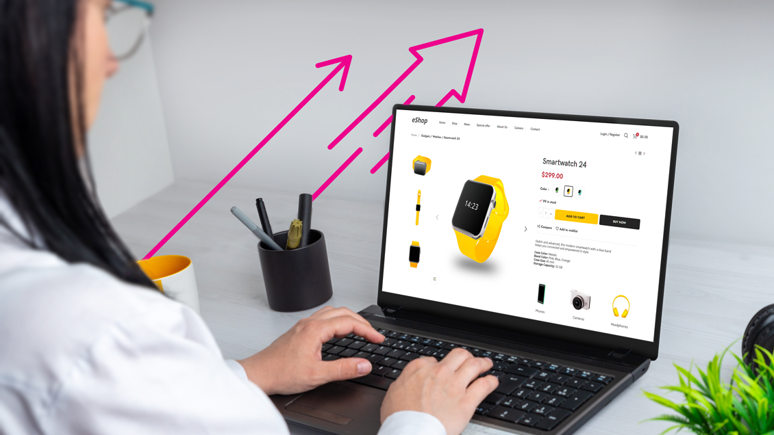 Woman sitting in front of computer showing a watch product page with a pink arrow next to computer point up to show upward sales trend.